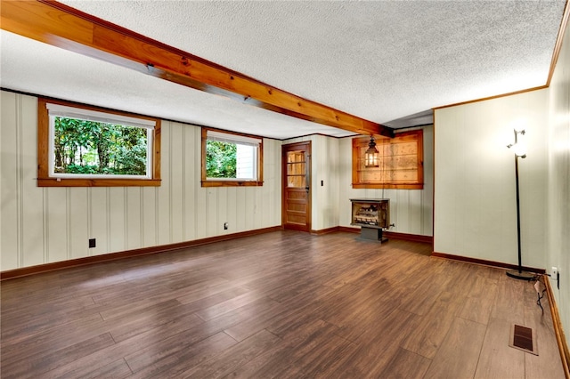 unfurnished room featuring a textured ceiling, beam ceiling, and hardwood / wood-style flooring