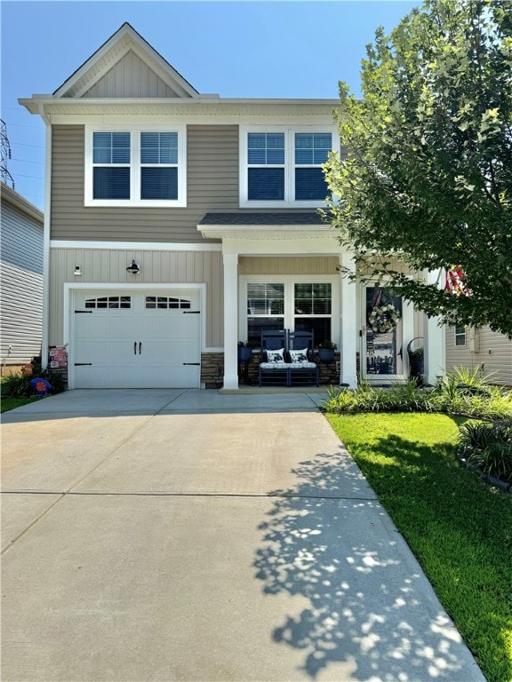 view of front of property with a garage and a front lawn