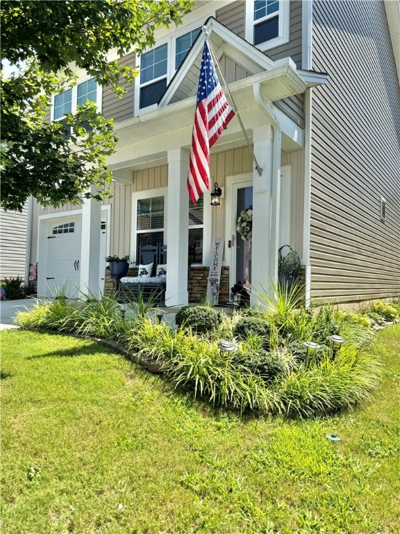 view of front facade featuring a front lawn, a porch, and a garage