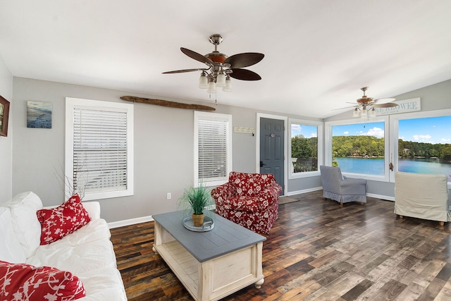 living room featuring a water view, vaulted ceiling, ceiling fan, and dark hardwood / wood-style flooring