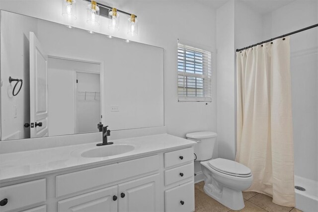 bathroom featuring vanity, toilet, tile patterned floors, and a shower with curtain