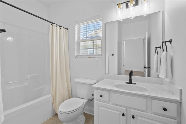 full bathroom featuring vanity, tile patterned floors, toilet, and shower / bath combo