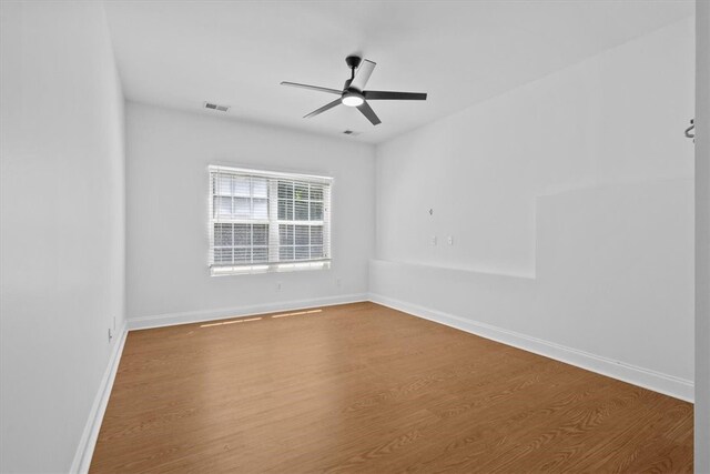 empty room featuring wood-type flooring and ceiling fan