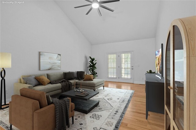 living room with ceiling fan, french doors, hardwood / wood-style floors, and high vaulted ceiling