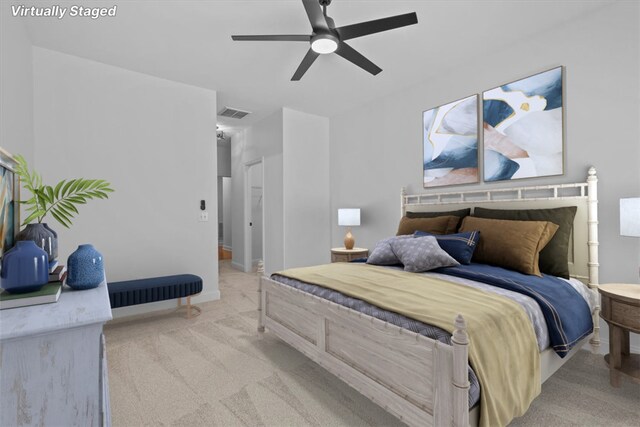 bedroom featuring light carpet and ceiling fan