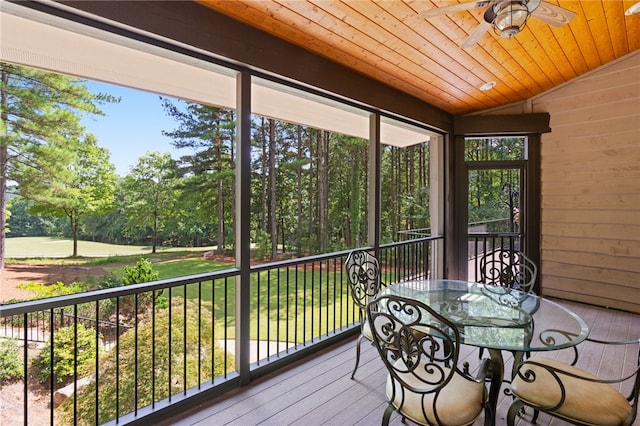 unfurnished sunroom featuring wood ceiling, vaulted ceiling, and ceiling fan