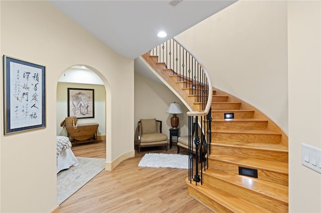 stairs featuring hardwood / wood-style floors