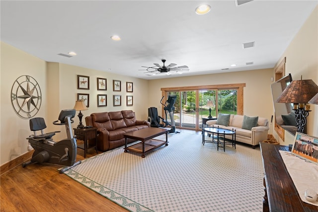 living room featuring wood-type flooring and ceiling fan