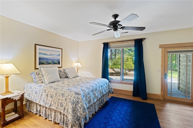 bedroom with wood-type flooring, ceiling fan, and access to exterior