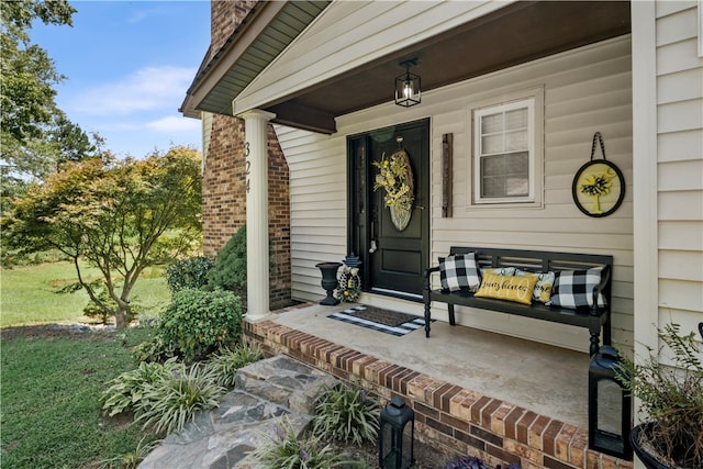 view of exterior entry with a porch