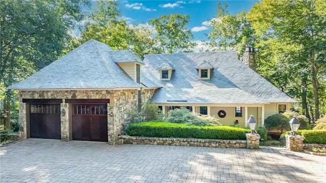 cape cod home with a garage