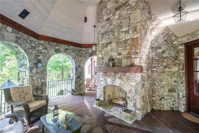 living room with high vaulted ceiling, wood-type flooring, and a fireplace