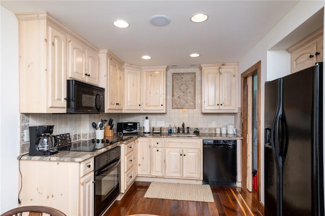 kitchen featuring black appliances, backsplash, dark wood-type flooring, and sink