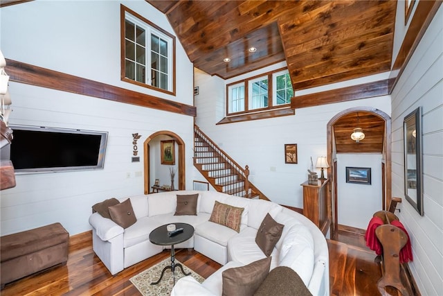 living room featuring wood ceiling, wood-type flooring, wooden walls, and high vaulted ceiling