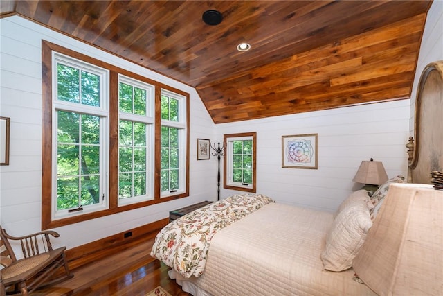 bedroom featuring vaulted ceiling, wood ceiling, wood walls, and hardwood / wood-style floors