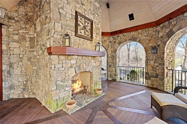 deck featuring an outdoor stone fireplace