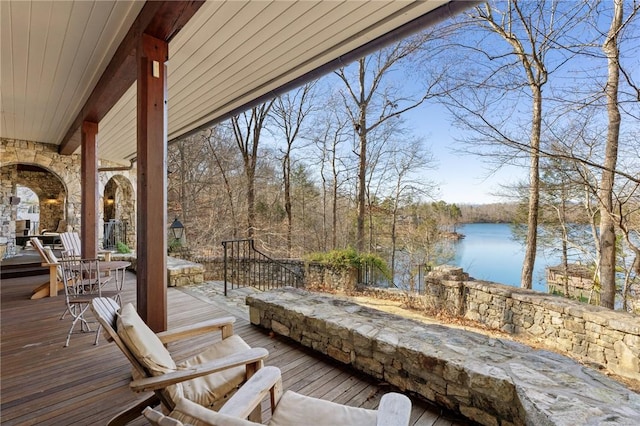 wooden terrace featuring a water view