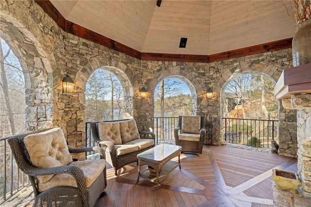 interior space featuring high vaulted ceiling and hardwood / wood-style flooring