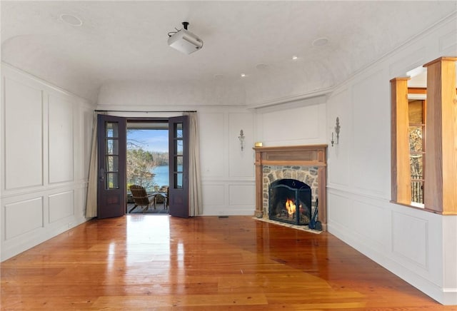 unfurnished living room with a fireplace and wood-type flooring