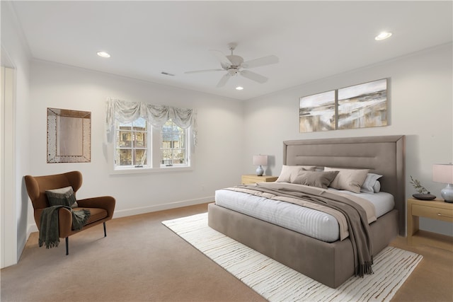 bedroom featuring ceiling fan, crown molding, and carpet flooring