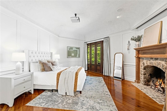 604 Top Ridge Dr, Sunset, SC 29685 - bedroom featuring a decorative wall, dark wood-style floors, and a fireplace
