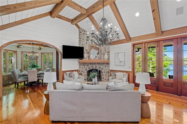 604 Top Ridge Dr, Sunset, SC 29685 - living area featuring arched walkways, light wood-style floors, french doors, and an inviting chandelier