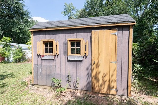 view of outbuilding with a lawn