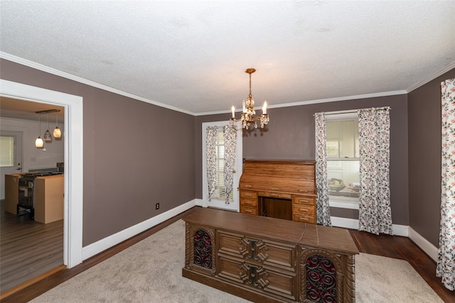 living room featuring wood-type flooring, ornamental molding, plenty of natural light, and a chandelier