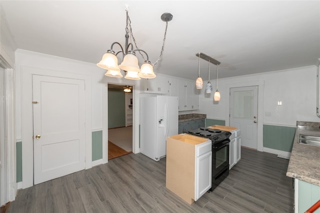 kitchen with white refrigerator with ice dispenser, black electric range, decorative light fixtures, and white cabinets