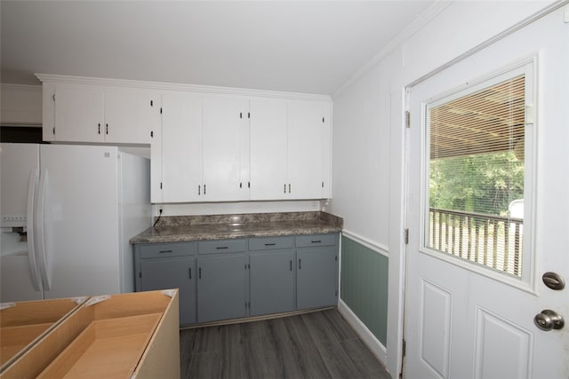 kitchen with ornamental molding, gray cabinets, dark hardwood / wood-style floors, and white refrigerator with ice dispenser