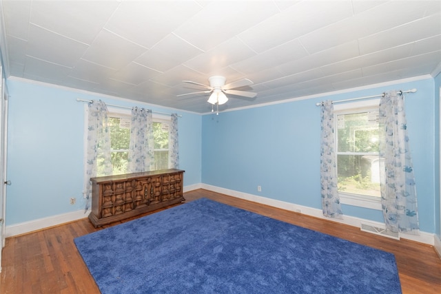 unfurnished room with ceiling fan, dark hardwood / wood-style floors, and crown molding