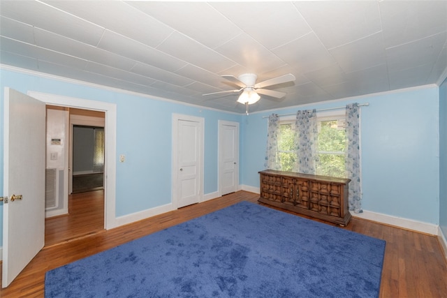 bedroom with ceiling fan, ornamental molding, and dark hardwood / wood-style flooring