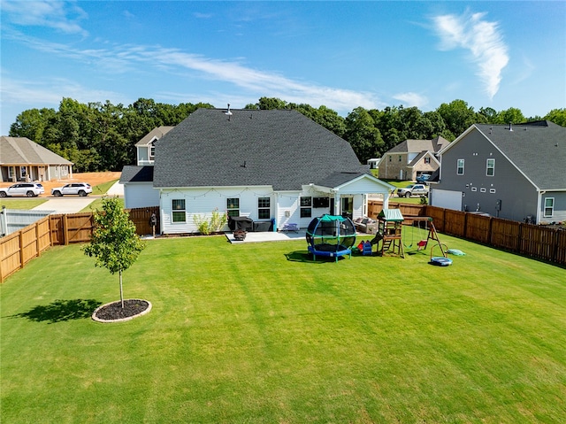 rear view of house featuring a patio area and a yard