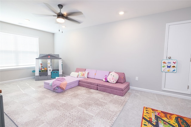 game room with ceiling fan and light colored carpet