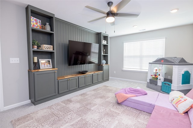 living room featuring light carpet and ceiling fan