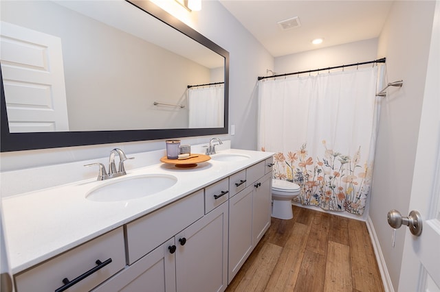 bathroom featuring hardwood / wood-style floors, vanity, toilet, and a shower with curtain