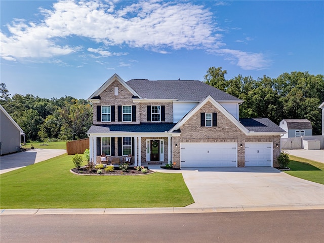 craftsman inspired home featuring covered porch and a front yard