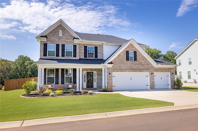 craftsman inspired home featuring a garage, a porch, and a front lawn