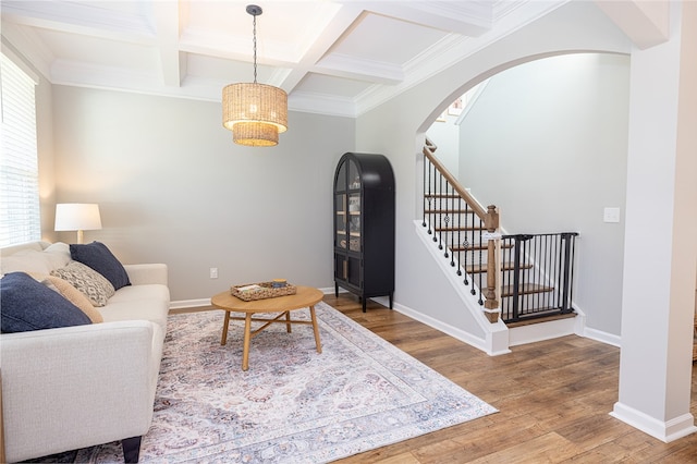 living room featuring coffered ceiling, beamed ceiling, hardwood / wood-style flooring, and crown molding