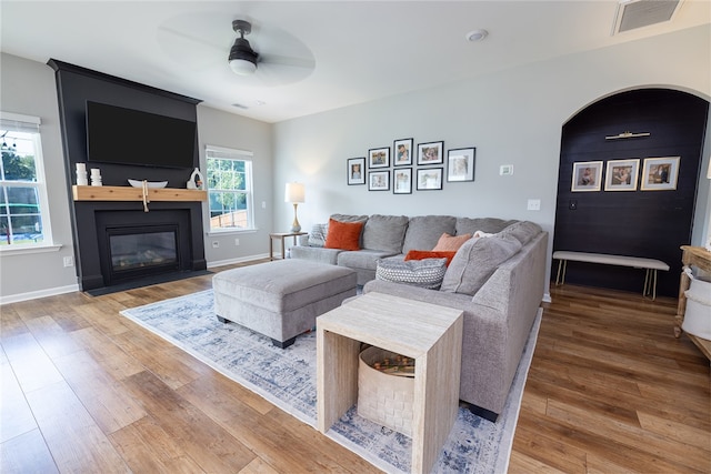 living room with ceiling fan and hardwood / wood-style flooring