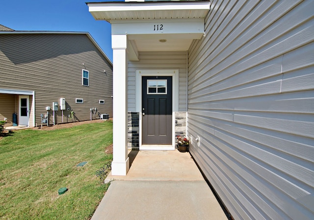 property entrance with a yard