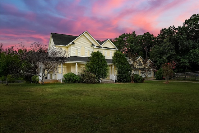 view of front of house featuring a yard and covered porch