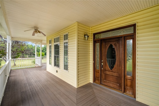 doorway to property featuring ceiling fan and covered porch