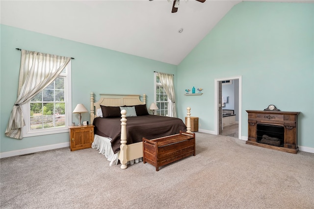 carpeted bedroom featuring ceiling fan, ensuite bath, and high vaulted ceiling