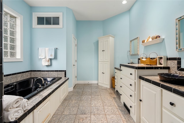 bathroom with a bathing tub and vanity