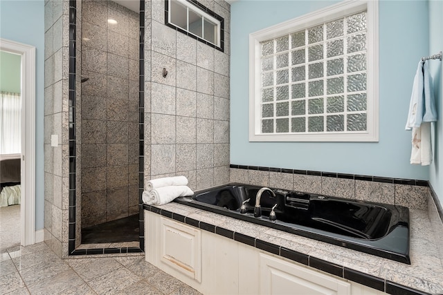 bathroom with plus walk in shower and tile patterned floors