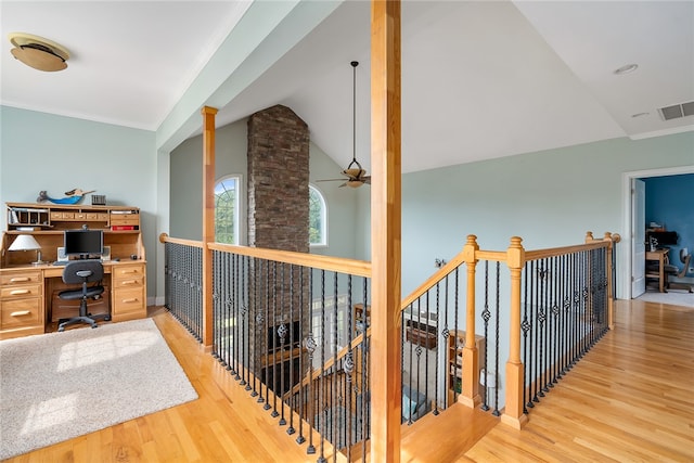 office featuring ornamental molding, vaulted ceiling, light hardwood / wood-style floors, and ceiling fan