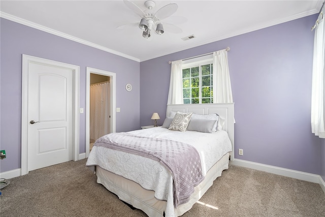 carpeted bedroom with crown molding and ceiling fan