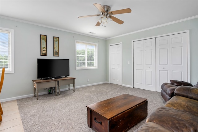 living room featuring ornamental molding, light carpet, and ceiling fan