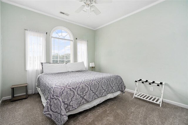 carpeted bedroom with crown molding and ceiling fan